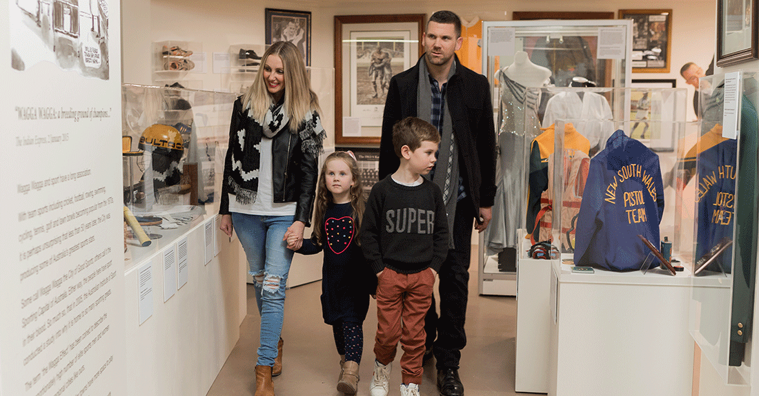 Family browsing through the Wagga Wagga Sporting Hall of Fame on display at the Museum of the Riverina Botanic Gardens site